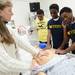 University of Michigan Dr. Suzanne L Dooley-Hash, MD instructs Cass Tech freshman Silas Shorter, Frankie Bryant  and Devin Moses as they check the vitals of a dummy during a tour o f the Clinical Simulation Center at University of Michigan Hospital on Thursday, Jan. 10. Melanie Maxwell I AnnArbor.com